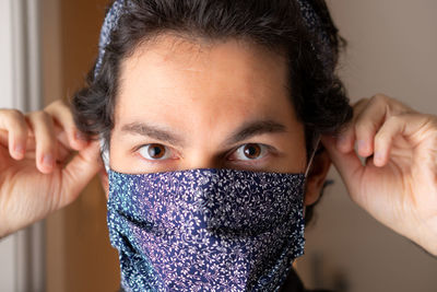 Close-up portrait of teenage girl covering face