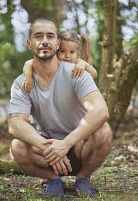 Portrait of boy sitting on field