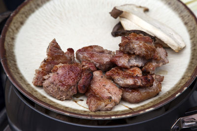 High angle view of meat and mushroom in plate