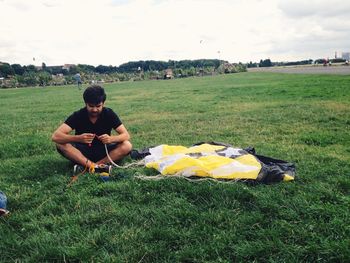 Man looking at grassy field