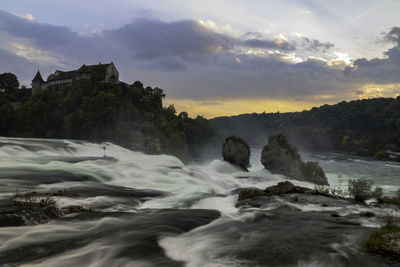 Scenic view of waterfall against sky