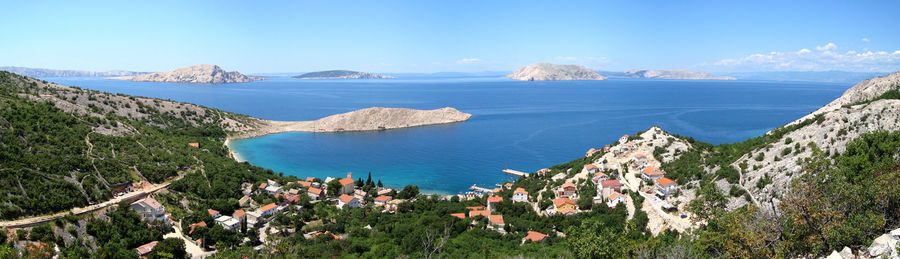 Panoramic shot of sea against clear blue sky