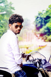 Portrait of young man riding sunglasses