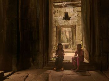 Women sitting in corridor of building