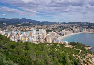 Panoramic view of buildings and mountains against sky