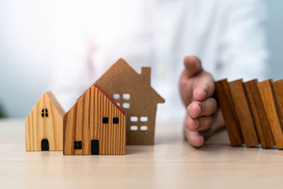 Close-up of hand holding wooden table