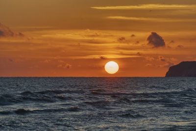 Scenic view of sea against orange sky