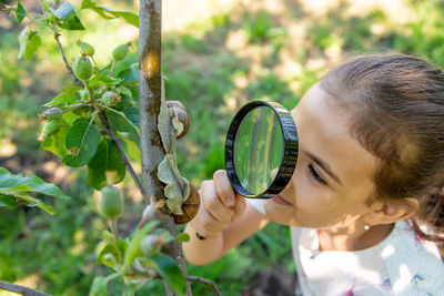 Close-up of boy blowing bubble