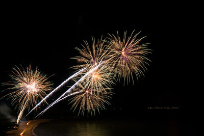 Low angle view of firework display at night