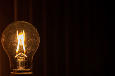 Close-up of illuminated light bulb