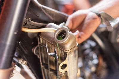 Cropped hand holding motorcycle part