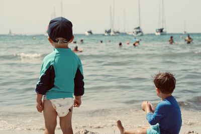 Side view of boy standing at beach