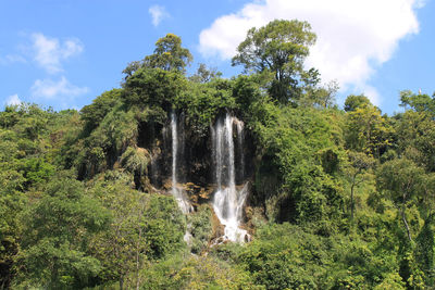 Scenic view of waterfall against sky