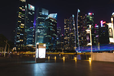 Illuminated buildings against sky at night