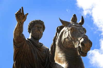Bronze roman equestrian statue of emperor marcus aurelius, against the blue sky. rome, italy