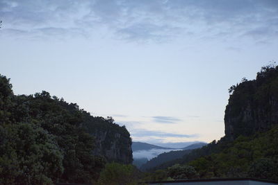 Scenic view of mountains against cloudy sky