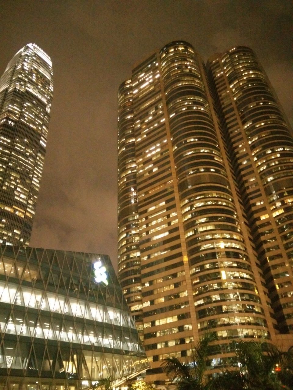 architecture, building exterior, built structure, skyscraper, low angle view, modern, tall - high, city, night, illuminated, tower, office building, building, sky, tall, reflection, capital cities, financial district, glass - material, no people