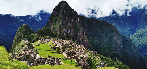 Panoramic view of mountain range against cloudy sky