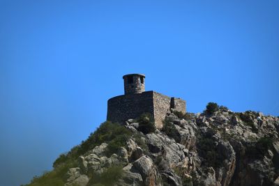 Low angle view of castle against clear blue sky