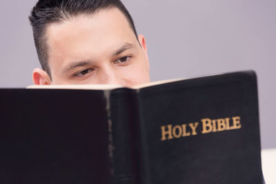 Man reading bible at home