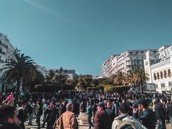 Group of people in front of buildings