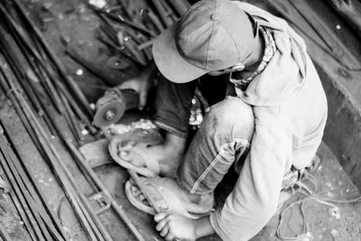 High angle view of men working with toy