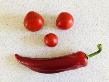 Directly above shot of red chili peppers on white background