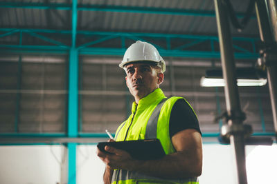 Rear view of man standing in factory