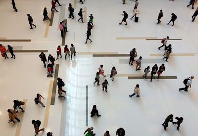 High angle view of people walking across atrium