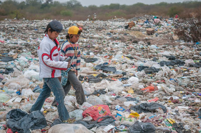 People standing by garbage