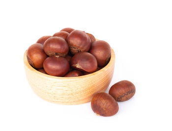 Close-up of fruits in bowl against white background