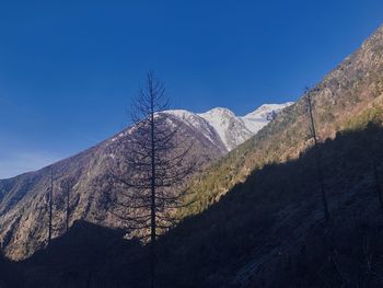 Scenic view of mountains against clear blue sky