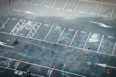 High angle view of people walking on road