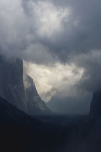 Scenic view of mountains against cloudy sky