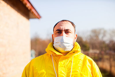 Portrait of man wearing mask standing outdoors