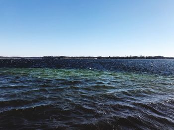 Scenic view of sea against clear blue sky