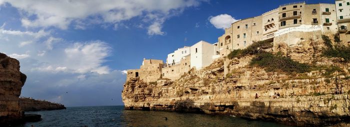 Panoramic view of sea and buildings against sky