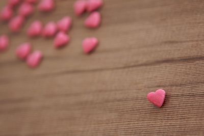 High angle view of pink heart shape candies on table