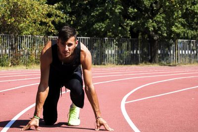 Full length of young man posing for marathon