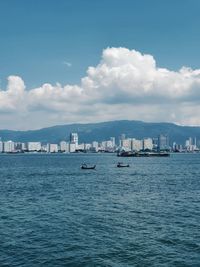 Sailboats in sea against sky