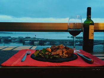 Breakfast served on table in restaurant against sky