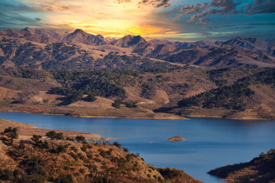 Scenic view of sea and mountains against sky