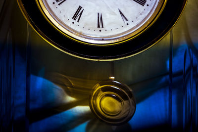 Close-up of clock with pendulum