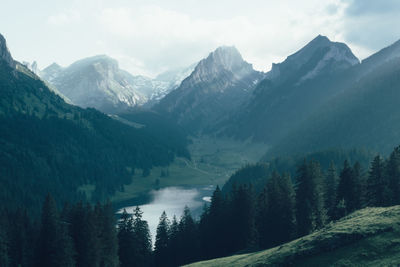 Scenic view of river with mountains in background