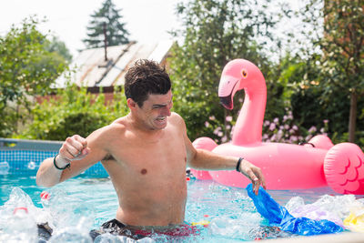 Full length of shirtless boy in swimming pool