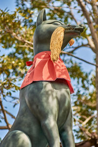 Low angle view of statue against trees