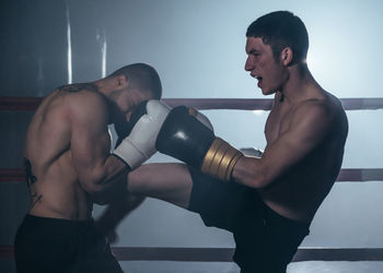 Side view of man exercising in gym