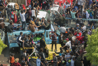 High angle view of people on car enjoying at water festival