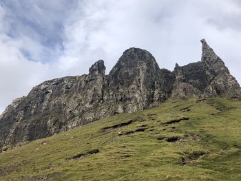 Low angle view of rocks on mountain against sky