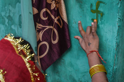 Close-up of hands against wall